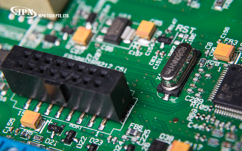 A multi-pin header connector for a green PCB.