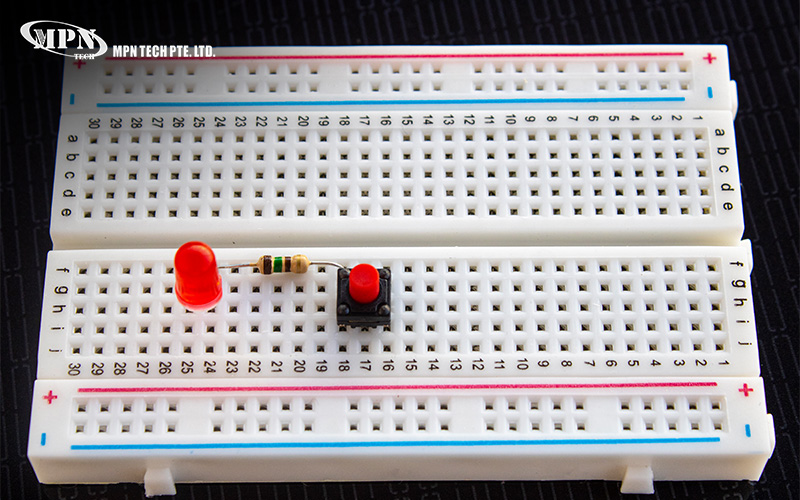 Simple LED circuit built on a white breadboard prototype.