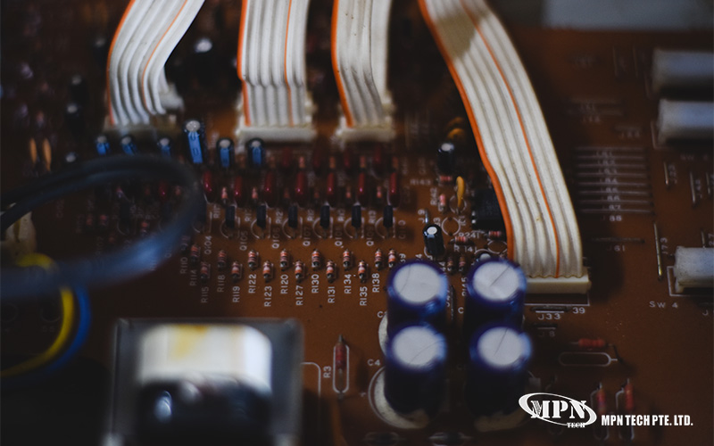 Close-up of circuit board with labeled components and ribbon cables.