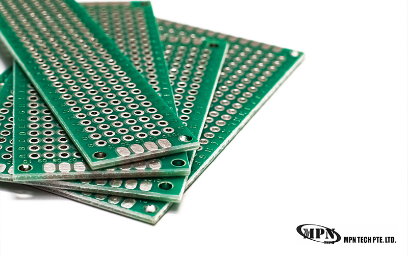 Stack of green perforated electronic circuit boards