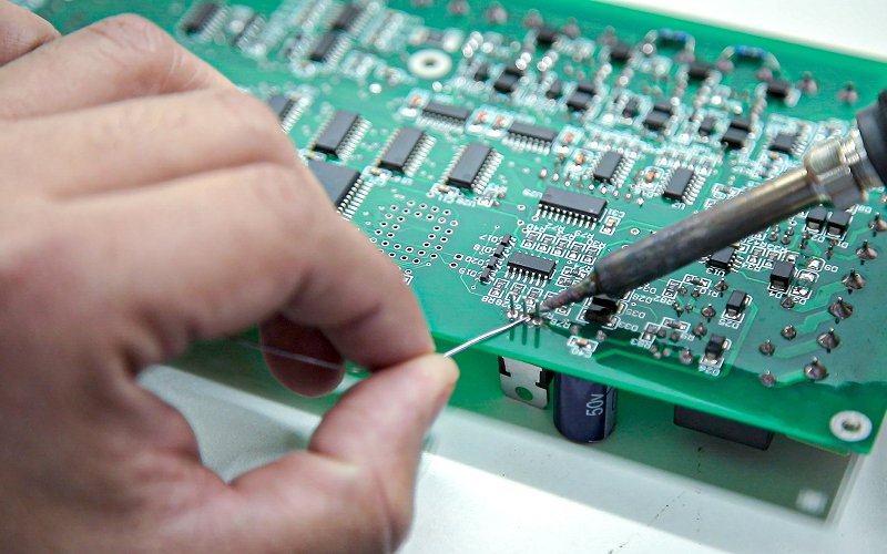 Technician-soldering-SMD-components-onto-a-PCB-board