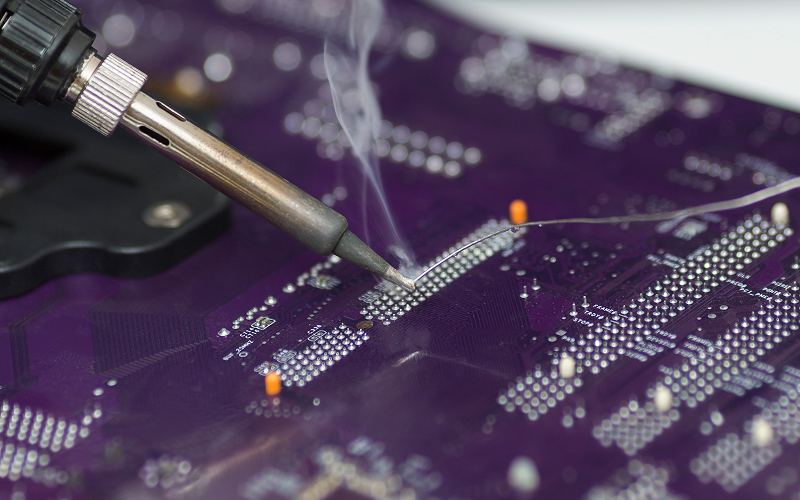 Close-up-of-soldering-iron-during-through-hole-assembly-process