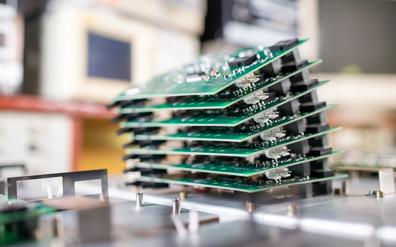 Stacked printed circuit boards tested for manufacturing tolerances and reliability