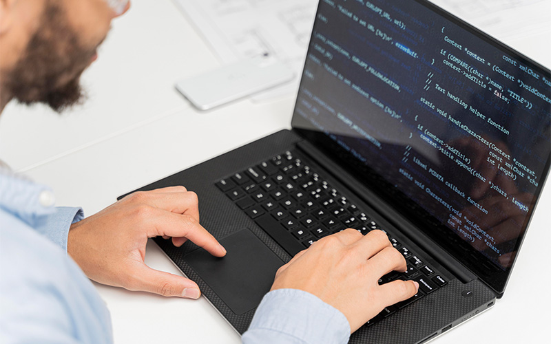 engineer working on code for electronics manufacturing