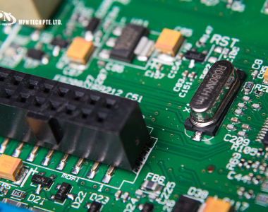 A multi-pin header connector for a green PCB.