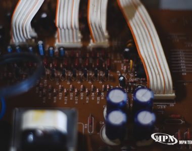 Close-up of circuit board with labeled components and ribbon cables.