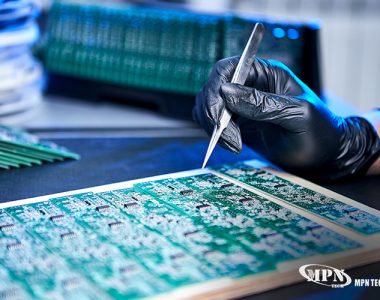 Technician inspecting PCB assembly following IPC standards