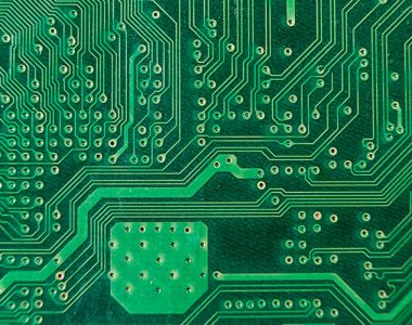 Close-up of intricate PCB trace routing connecting electronic components.