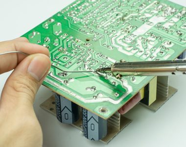 technician soldering joints on a printed circuit board